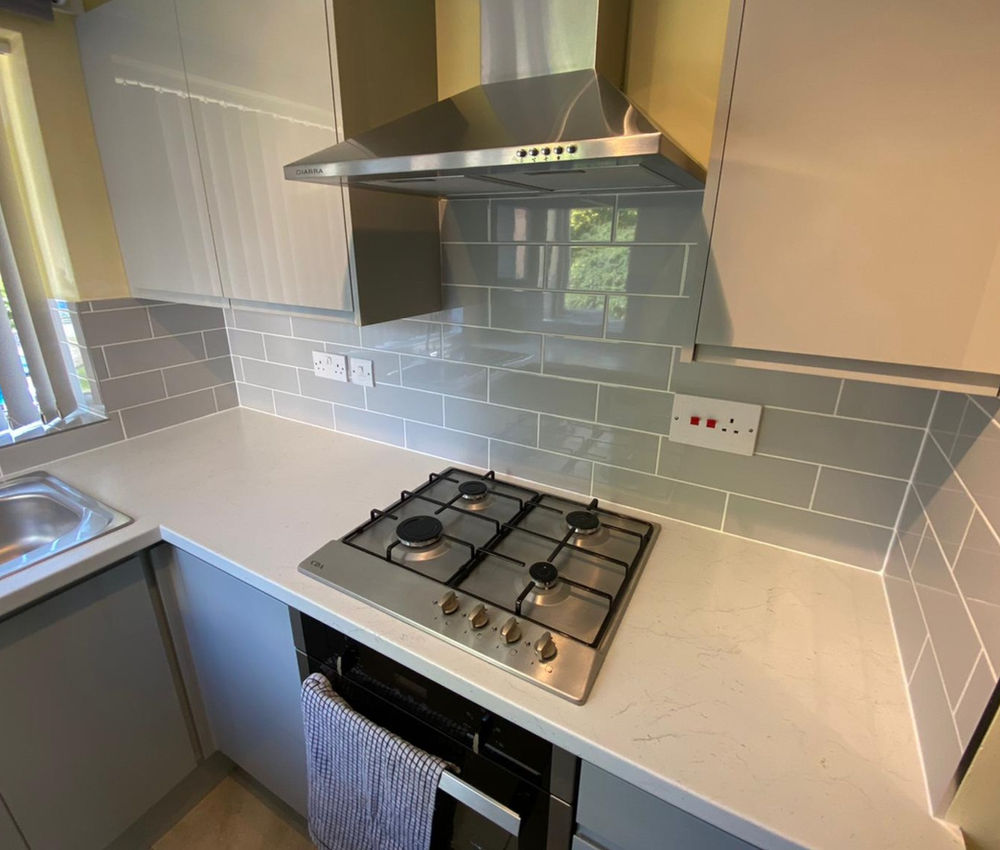 Completed kitchen installation with gas appliances