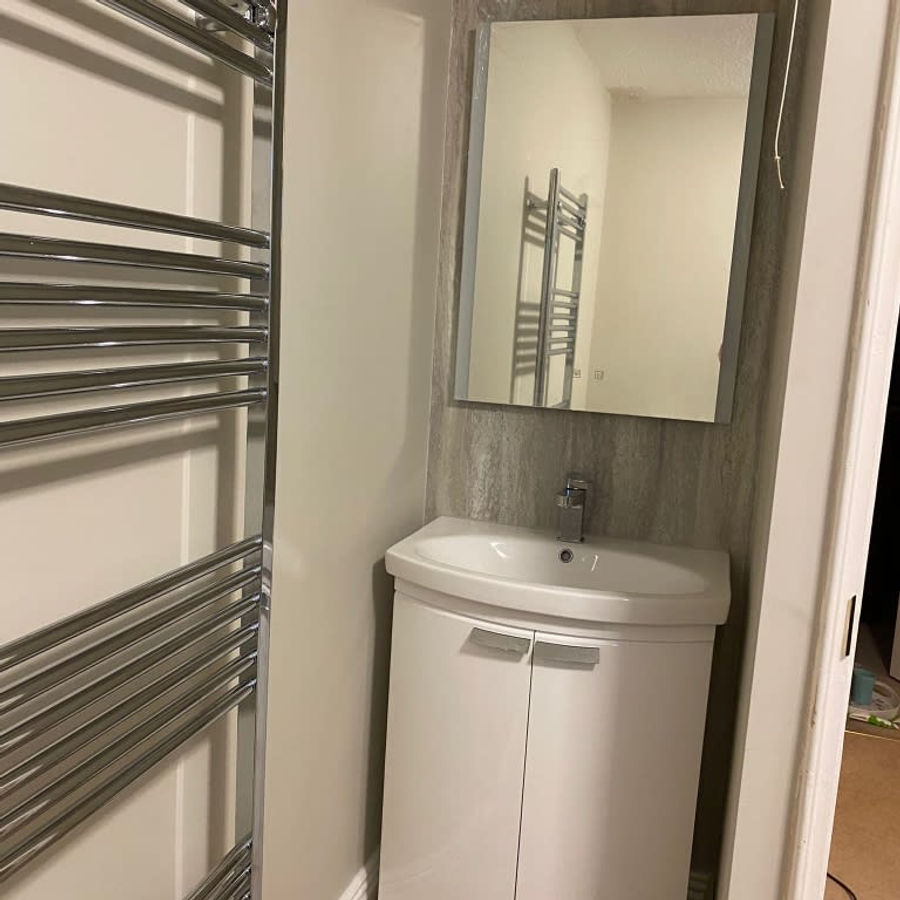 Wash basin and heated towel rail