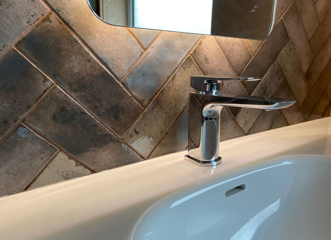 Basin with a tiled splashback